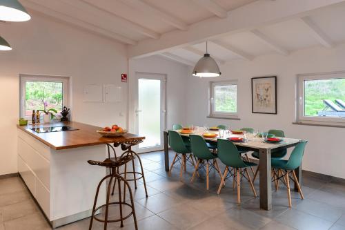 a kitchen and dining room with a table and chairs at wecamp Reserva Alecrim in Santiago do Cacém