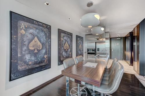 a dining room with a wooden table and chairs at The Lindo Cafaro Suite at Palms Place in Las Vegas