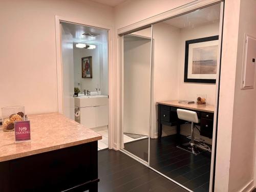 a bathroom with a sink and a desk with a mirror at LakeView 2Bdrms 2Baths with 3 real beds and parking in Toronto