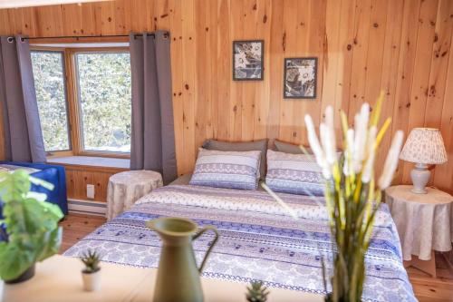 a bedroom with a bed in a wooden cabin at Lake View Loft in Severn
