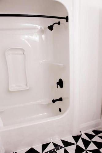 a bathroom with a bath tub with a sink at Large Waterfront Home w 5 Ensuite Bathrooms in Belleville