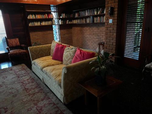 a living room with a couch and a brick wall at Tranquility Estate in Kingston