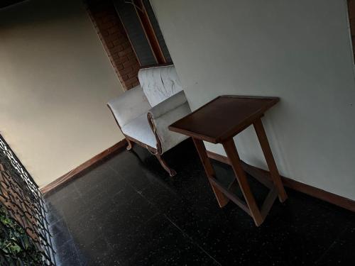 a table and a chair next to a side table at Tranquility Estate in Kingston