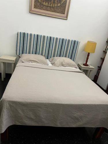 a bedroom with a large bed with a striped headboard at Tranquility Estate in Kingston