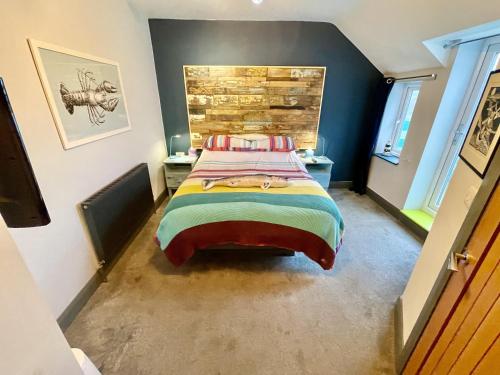 a bedroom with a large bed in a room at Cod in Seahouses