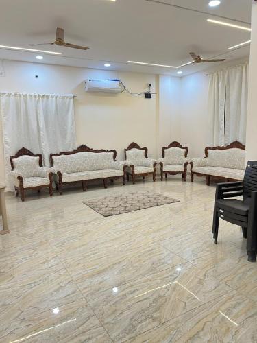 a room with a bunch of chairs in a room at luxurious farmhouse VILLA GRAND in Venkatāpur