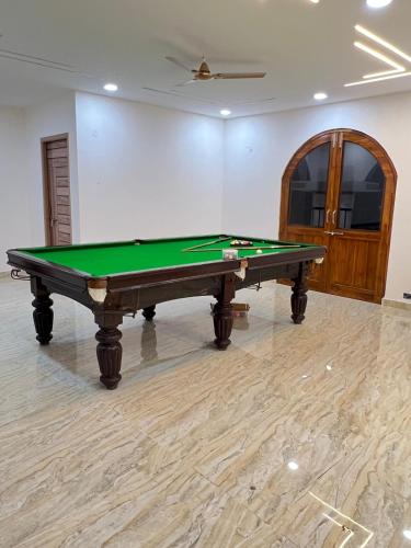 a pool table in the middle of a room at luxurious farmhouse VILLA GRAND in Venkatāpur