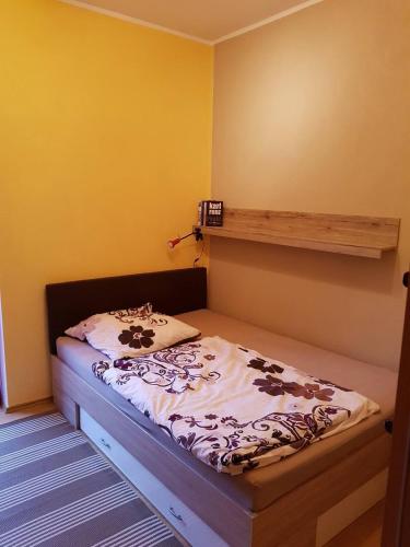 a small bed in a room with yellow walls at FeWo Köt- 3 Ferienwohnungen im historischen Köthener Stadtkern in Köthen
