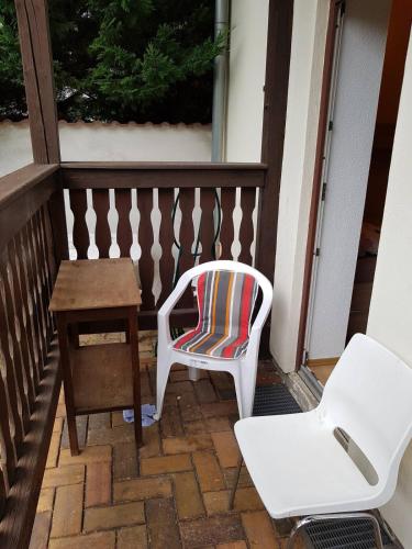 a white chair sitting next to a table and a stool at FeWo Köt- 3 Ferienwohnungen im historischen Köthener Stadtkern in Köthen