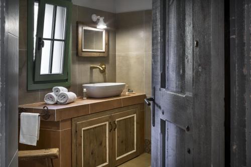 a bathroom with a sink and a mirror at Gallicantu Stazzo Retreat in Luogosanto
