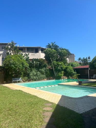a swimming pool in the middle of a yard at Amanzimtoti , 36 Ocean Breeze ,warner beach, kingsburg in Kingsburgh