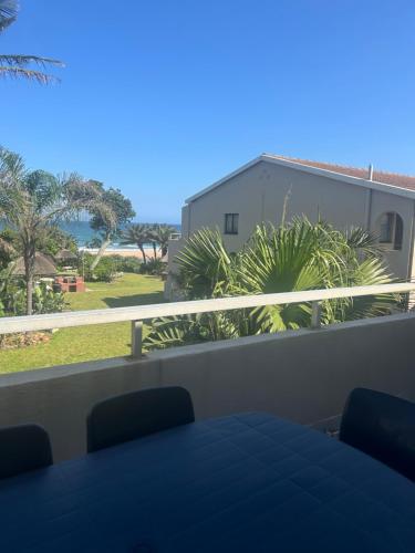 a balcony with a table and a view of the ocean at Amanzimtoti , 36 Ocean Breeze ,warner beach, kingsburg in Kingsburgh
