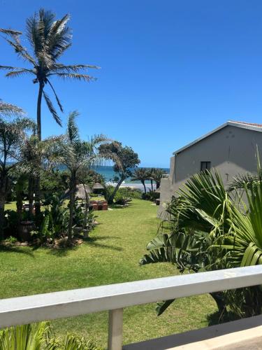 a view of a yard with a palm tree at Amanzimtoti , 36 Ocean Breeze ,warner beach, kingsburg in Kingsburgh