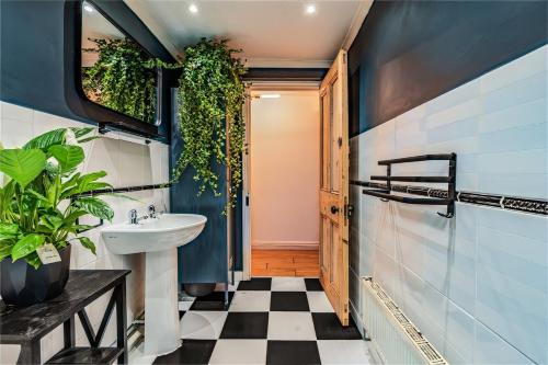 a bathroom with a black and white checkered floor at Pet-friendly flat w/ garden patio & smart tv in Bristol