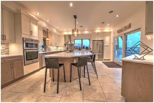 a large kitchen with a table and chairs in it at Villa Santorini in Gary