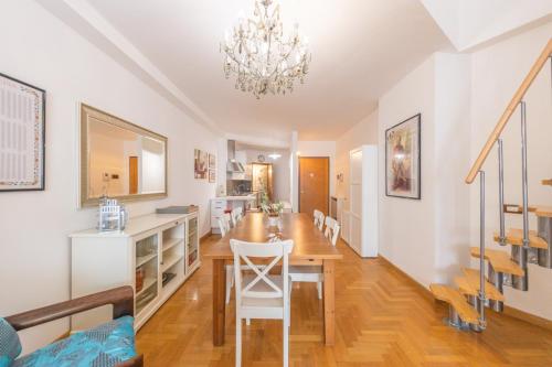 a dining room and kitchen with a table and chairs at Casa Anna in Frascati