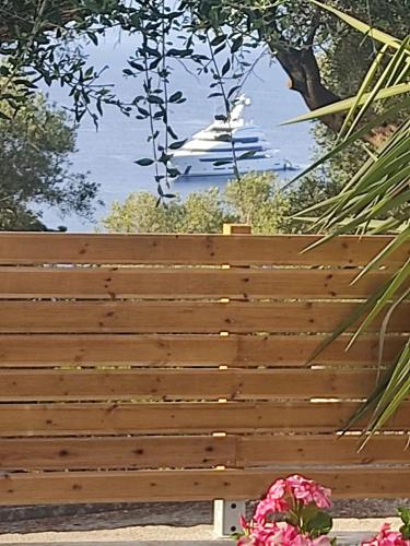a wooden bench with flowers in front of it at Suite Home Villa Paxos in Gaios