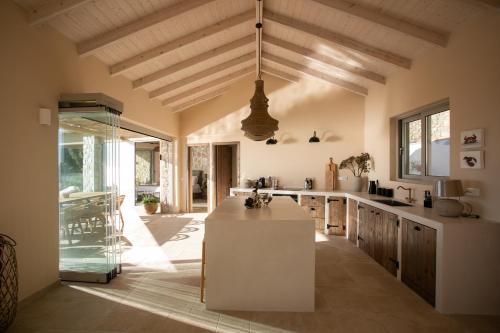 a kitchen with a white island in a room at Villa Elysium Parga in Parga