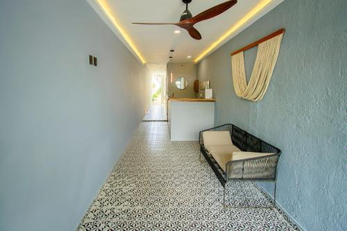 a hallway with a couch and a ceiling fan at Hotel Paso del Mar Playa del Carmen in Playa del Carmen