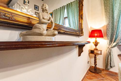 a statue of a woman sitting on a shelf in a room at Artist's Suites in Spoleto