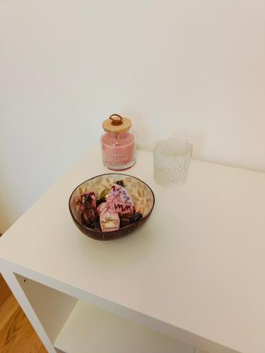 a table with a bowl of donuts and a candle at Villa Petra - Πέτρα in Alpignano
