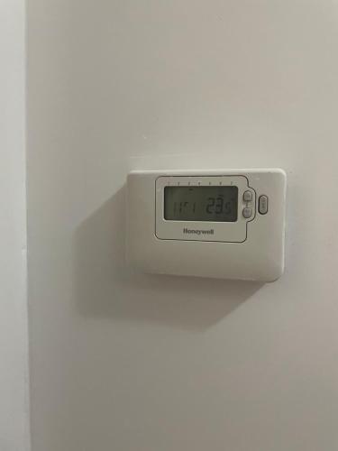 a clock is hanging on a white wall at 7 people - 1 price - Cozy attic apartment in Prešov