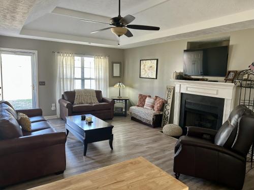a living room with leather furniture and a fireplace at Mount Juliet Charmer in Hunters Store