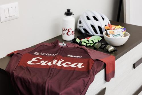 a table with a jacket and a helmet on it at Siena Living Apartment in Siena