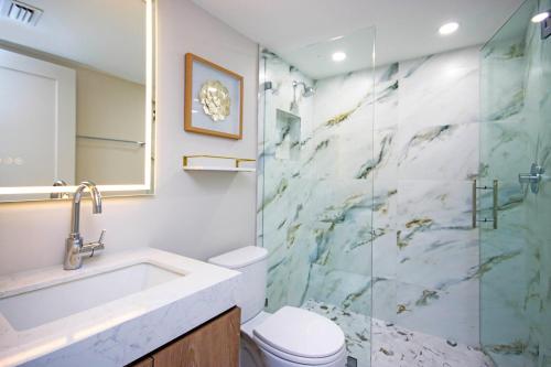 a bathroom with a sink and a toilet and a shower at Stylish 2BR Sanibel Condo With Amazing Beach Views 5C2 in Sanibel