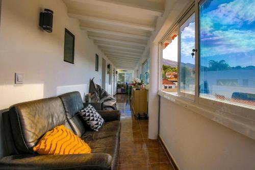 a living room with leather furniture and a large window at Luxury Private Complex in Albir