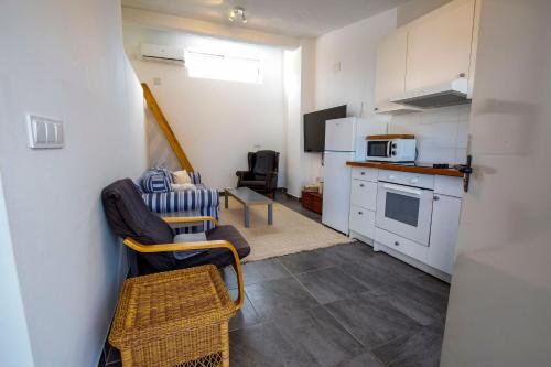 a small kitchen with white cabinets and a table and chairs at Luxury Private Complex in Albir