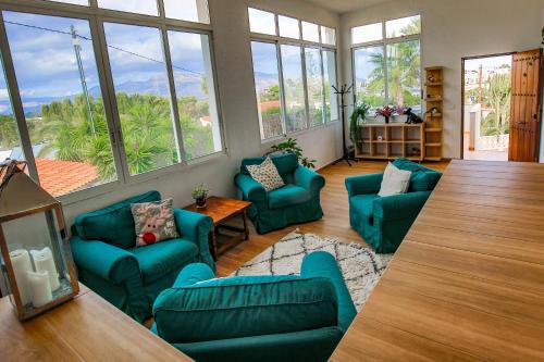 a living room with blue furniture and large windows at Luxury Private Complex in Albir