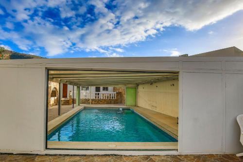 a swimming pool in a building with a large window at Luxury Private Complex in Albir