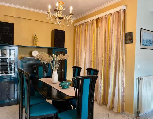 a dining room with a black table and chairs at Casa al Cuore Lefkas in Lefkada Town