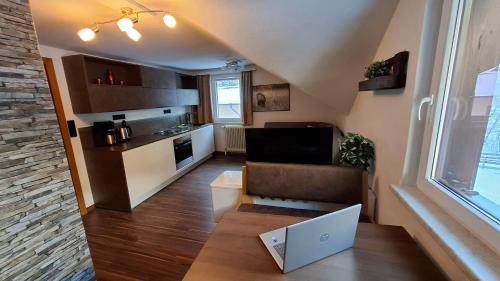a small living room with a couch and a laptop at Villa Anna in Bad Gastein