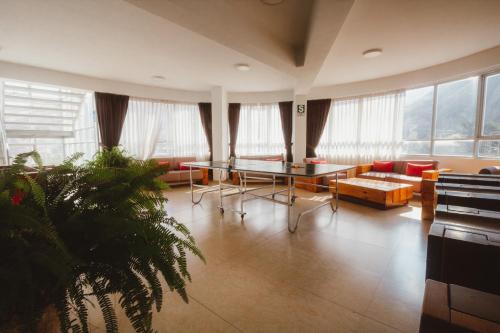 a living room with a table and a couch at Hacienda del Valle Sagrado in Urubamba