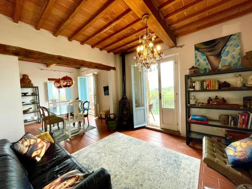 a living room with a couch and a chandelier at Spectacular Views from Private Apartment in a Local Umbrian Village in Gioiella