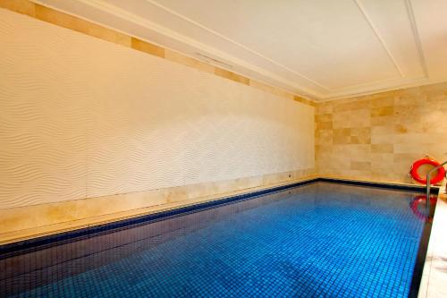 a swimming pool with a large blue tile wall at Taj Cape Town - Spacious 5 star luxury residence with kitchenette in Cape Town