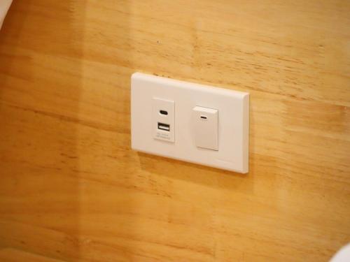 a white electrical outlet on a wooden floor at Moya Boutique Hotel in Betong
