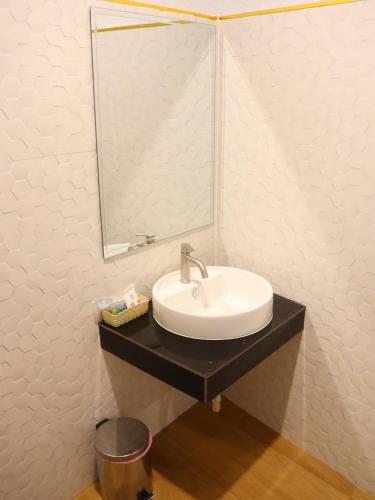 a bathroom with a sink and a mirror at Moya Boutique Hotel in Betong