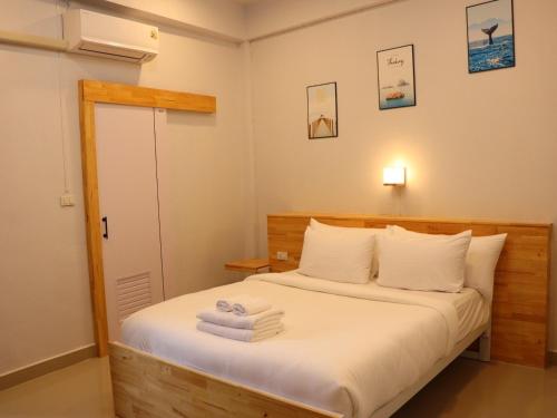 a bedroom with a bed with towels on it at Moya Boutique Hotel in Betong