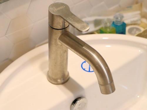 a sink with a silver faucet in a bathroom at Moya Boutique Hotel in Betong