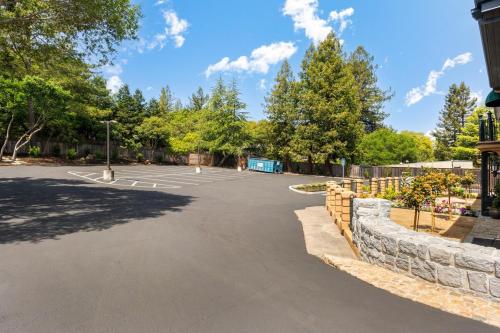 a parking lot at a park with trees at Deluxe King Suite at the Historic Stonehouse Inn! in Santa Rosa