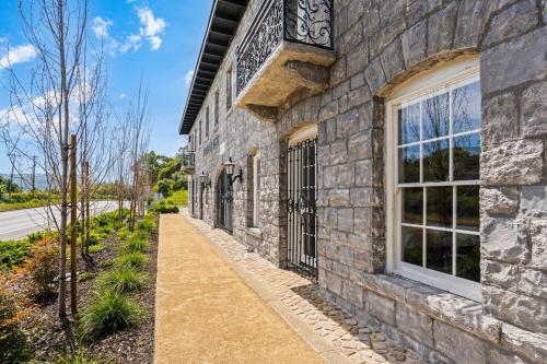 a stone building with a window and a sidewalk at Deluxe King Suite at the Historic Stonehouse Inn! in Santa Rosa