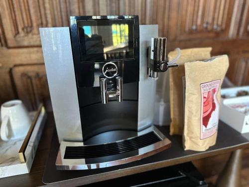 a coffee maker sitting on top of a table at Deluxe King Suite at the Historic Stonehouse Inn! in Santa Rosa