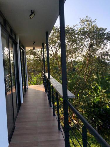 a balcony of a house with a bench on it at Alojamiento rural san joaquin in Quimbaya
