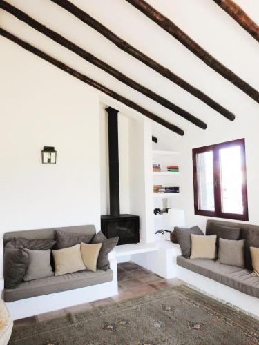 a living room with two couches and a fireplace at Casas da Serra d'Ossa - Casa da Horta in Glória