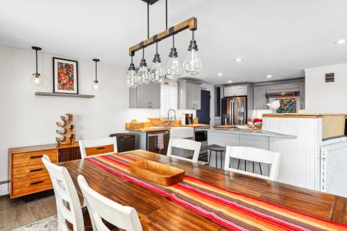 a kitchen and dining room with a wooden table and chairs at Lakeshore Vermont in Colchester