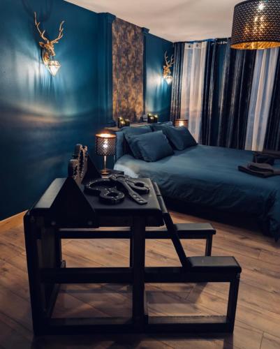 a bedroom with a bed and a table in front of a bed at Bliss loveroom in Langres