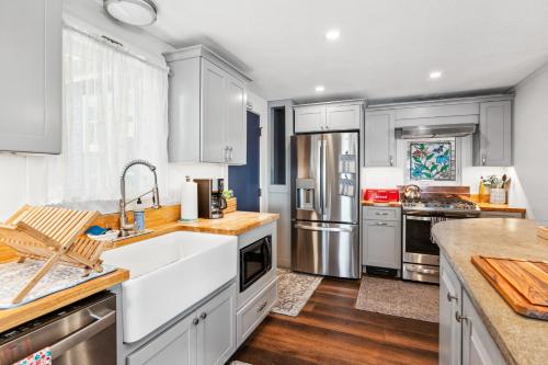 a kitchen with white cabinets and stainless steel appliances at Lakeshore Vermont in Colchester